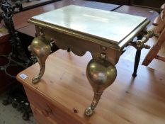 A brass footman together with a brass and wrought iron companion set