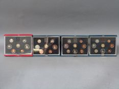 Four Royal Mint deluxe cased coin collections comprising 1983, 1984,