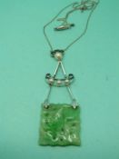 A 1920's 9ct white gold necklace set with a carved jadeite plaque and pearls