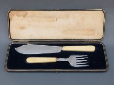 A cased set of George V hallmarked silver ivory-handled fish servers, Sheffield 1911,