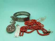A Victorian silver bangle, coral necklace,