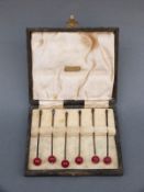A cased hallmarked silver set of cocktail sticks, B'ham 1934, length 8cm,