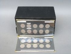 An amateur collection of English shillings mounted in cards, ranging from 1954-1957,