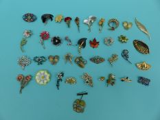 A collection of brooches in floral and foliate design to include enamel set etc