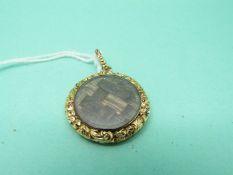 A Victorian mourning locket set with plaited hair