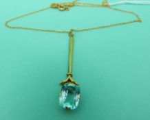 A 9ct gold pendant and chain set with a blue stone possibly topaz.