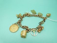 A 9ct gold charm bracelet with eight 9ct gold charms including a horse, St Christopher,