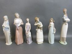 A collection of Lladro figurines including girls in gowns and with flowers
