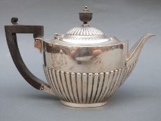 An Edward VII hallmarked silver teapot with fluted lower section, London 1906 maker's mark R & BJ,