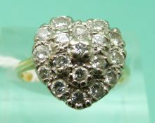 An 18ct gold ring set with round cut diamonds in a heart cluster setting (size L), weight 5.