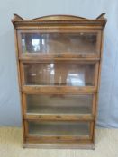 An oak Lebus four section bookcase with up and over style glazed doors (W88 x D36 x H158cm)