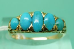 An 18ct gold ring set with oval turquoise cabochons (size O), weight 3.