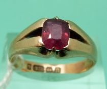 A 9ct gold ring set with a cushion cut garnet,