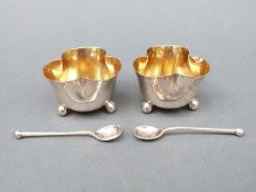 A pair of George V hallmarked trefoil shaped salts raised on three ball feet, Sheffield 1918,