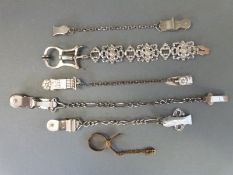 Six various skirt lifters including chained examples