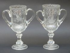 A pair of clear glass trophy/urn shaped glass celery vases with etched decoration,