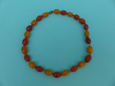 A necklace of alternating oval carnelian and amber beads,