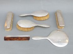 A hallmarked silver dressing table set comprising mirror,
