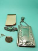 A Victorian mourning brooch set with seed pearls surrounded by a textured snake border,