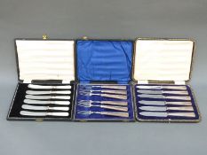 Two sets of hallmarked silver-handled cutlery and a set of mother-of-pearl handled knives