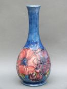 A Moorcroft pedestal vase in Anemone pattern on a blue ground, limited edition of 33/200,