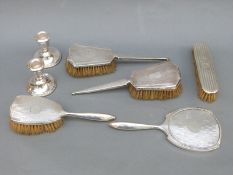 A quantity of hallmarked silver dressing table items comprising mirror and four various brushes,