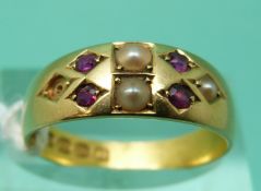 An 18ct gold ring set with seed pearls and rubies,