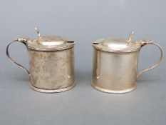 Two Edward VII hallmarked silver mustards, one with blue glass liner,