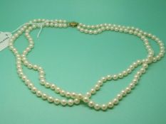 A double strand pearl necklace with 14ct gold clasp