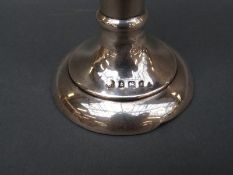 An Edward VII hallmarked silver trumpet vase with embossed floral decoration, Birmingham 1905,