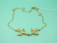 A 9ct gold necklace in the form of two swallows set with a garnet, weight 3.