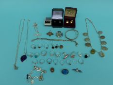 A collection of silver jewellery to include 21 silver rings, silver bangle,
