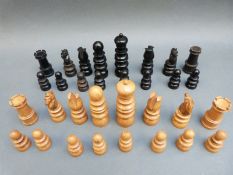 A turned and carved wooden chess set in wooden box. Height of king 8.