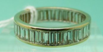 An 18ct gold ring set with 43 baguette cut diamonds in a channel setting, total diamond weight 2.