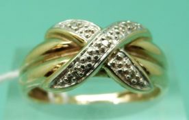 A 9ct gold ring set with diamonds in cross over design (size P), weight 2.