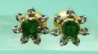A pair of 18ct gold earrings each set with a round cut apple green emerald to the centre surrounded