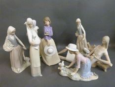A collection of Nao figures of young girls with various birds,