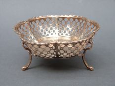 A George V hallmarked silver pierced basket or bon bon dish raised on three feet,