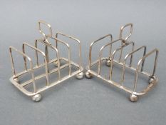 A pair of hallmarked silver four-slice toast racks, Sheffield 1930 and 1920, maker Atkin Brothers,