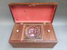 A 19thC crossbanded and inlaid mahogany tea caddy with mixing bowl flanked by tea compartments,