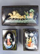 Three Russian lacquered boxes one with a scene of a horse and sleigh or Troika