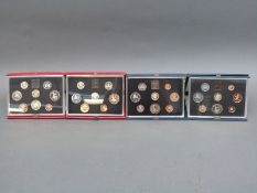 Four Royal Mint deluxe cased coin collections comprising 1983, 1984,