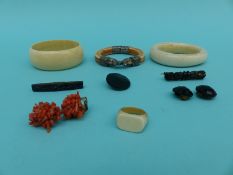 Three ivory bangles, a pair of coral earrings, an ivory ring,