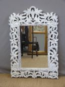 A painted mirror in carved frame (112 x 76cm)