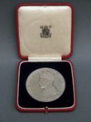 A cased 1937 silver commemorative medallion