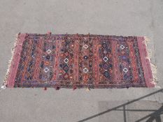 A possibly wedding or similar eastern rug or wall hanging (300 x 129cm)