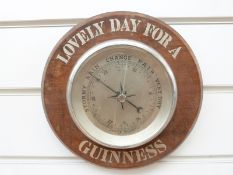 A vintage 'Lovely Day for a Guinness' chrome cased aneroid barometer, OC and anchor to dial,