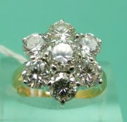 An 18ct gold ring set with seven round brilliant cut diamonds,