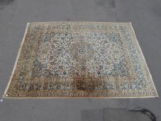 A large Persian rug on beige ground (410 x 307cm)