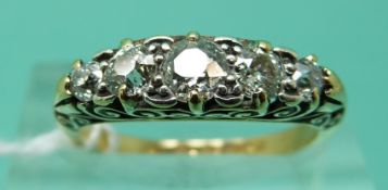 An 18ct gold ring set with five old English cut diamonds, the largest approximately 0.